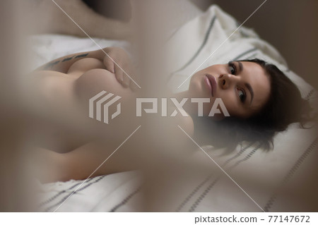 Sensual woman touching naked breast in bedroom Sensual woman touching naked breast in bedroom 77147672
