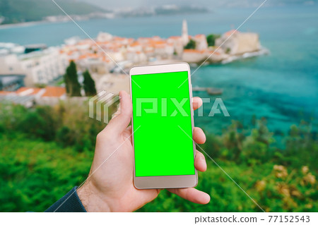 Smartphone with blank screen close up against the background of the ancient city Smartphone with blank screen close up against the background of the ancient city 77152543