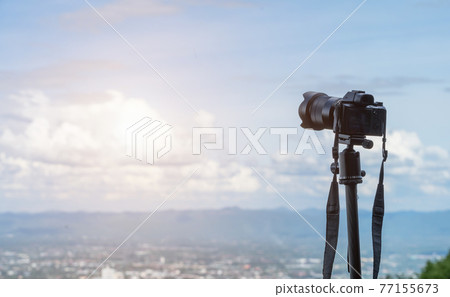 Mirrorless Camera capturing on admiring the view cityscape mountain range over the city air atmosphere bright blue sky background,Mirrorless on Tripod. Mirrorless Camera capturing on admiring the view cityscape mountain range over the city air atmosphere bright blue sky background,Mirrorless on Tripod. 77155673