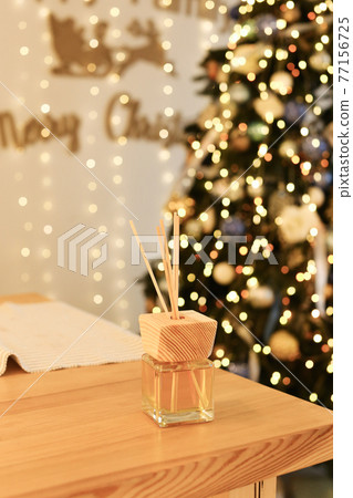 Aromatherapy reed diffuser air freshener on relaxed christmas background 77156725