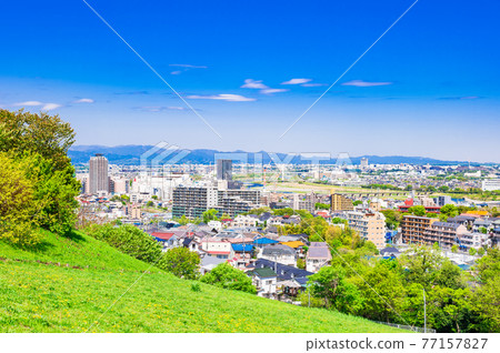 Residential area viewed from the fresh green hill 77157827