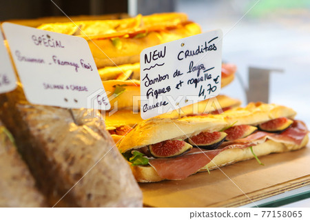 Baguette sandwich with figs and prosciutto in French boulangerie 77158065