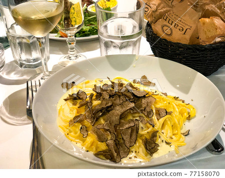 Truffle pasta and white wine at a French restaurant 77158070