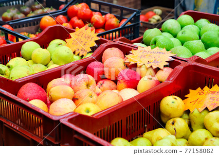 Lots of fruit in the rain-soaked blue sky market in France Lots of fruit in the rain-soaked blue sky market in France 77158082