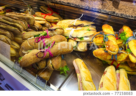 Lots of baguette sandwiches in French boulangerie 77158083