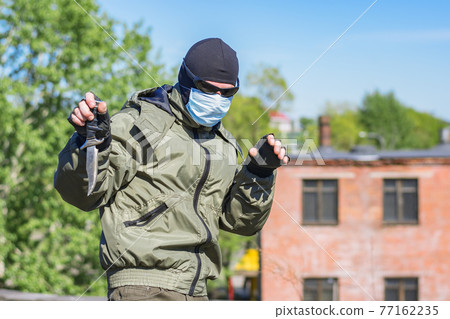 Dangerous Masked Criminal Surrenders to Authorities and Throws Weapons Dangerous Masked Criminal Surrenders to Authorities and Throws Weapons 77162235