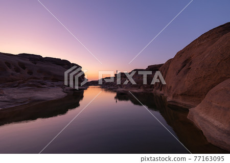 Sam Phan Bok, Ubon Ratchathani, Thailand. Dry rock reef in the Mekong River with mountain hills. Nature landscape background. Grand Canyon of Thailand. Sam Phan Bok, Ubon Ratchathani, Thailand. Dry rock reef in the Mekong River with mountain hills. Nature landscape background. Grand Canyon of Thailand. 77163095