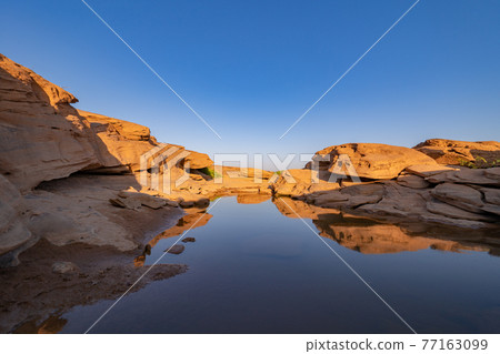 Sam Phan Bok, Ubon Ratchathani, Thailand. Dry rock reef in the Mekong River with mountain hills. Nature landscape background. Grand Canyon of Thailand. Sam Phan Bok, Ubon Ratchathani, Thailand. Dry rock reef in the Mekong River with mountain hills. Nature landscape background. Grand Canyon of Thailand. 77163099