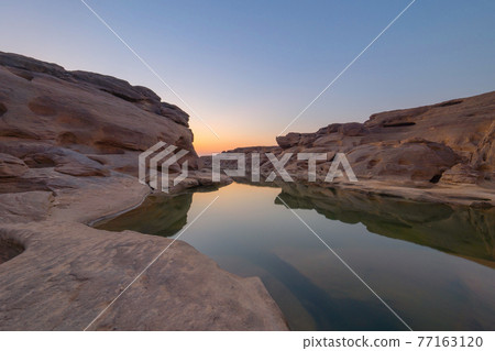 Sam Phan Bok, Ubon Ratchathani, Thailand. Dry rock reef in the Mekong River with mountain hills. Nature landscape background. Grand Canyon of Thailand. Sam Phan Bok, Ubon Ratchathani, Thailand. Dry rock reef in the Mekong River with mountain hills. Nature landscape background. Grand Canyon of Thailand. 77163120