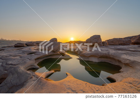 Sam Phan Bok, Ubon Ratchathani, Thailand. Dry rock reef in the Mekong River with mountain hills. Nature landscape background. Grand Canyon of Thailand. Sam Phan Bok, Ubon Ratchathani, Thailand. Dry rock reef in the Mekong River with mountain hills. Nature landscape background. Grand Canyon of Thailand. 77163126