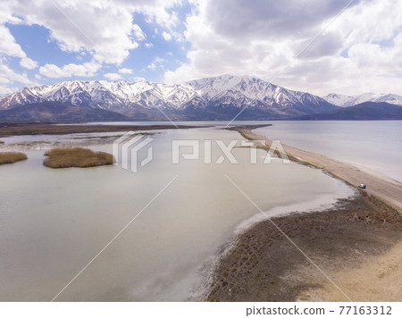 Aerial view of Highland Floodplains where Donemec River connecting to Lake Van surrounded with Mountains and Creating Thin Sandy Spit. Van is the largest lake in Turkey Aerial view of Highland Floodplains where Donemec River connecting to Lake Van surrounded with Mountains and Creating Thin Sandy Spit. Van is the largest lake in Turkey 77163312