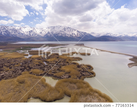 Aerial view of Highland Floodplains where Donemec River connecting to Lake Van surrounded with Mountains and Creating Thin Sandy Spit. Van is the largest lake in Turkey Aerial view of Highland Floodplains where Donemec River connecting to Lake Van surrounded with Mountains and Creating Thin Sandy Spit. Van is the largest lake in Turkey 77163314