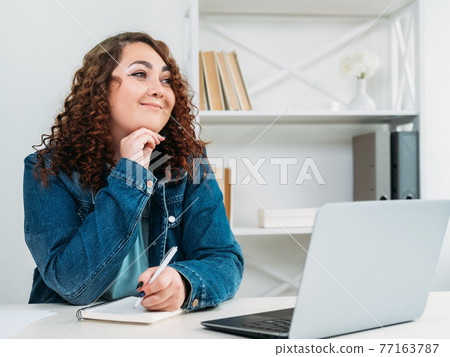 inspired woman planning vacation office interior 77163787