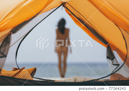 Naked Woman on the Beach with a Tent. Naked Woman on the Beach with a Tent. 77164243