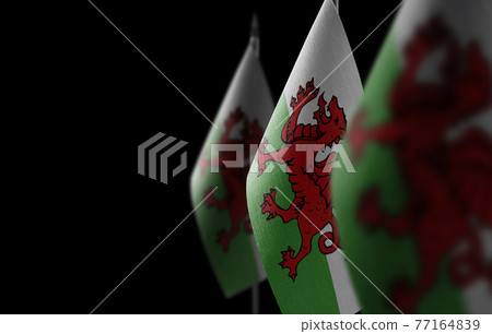 Small national flags of the Wales on a black background 77164839