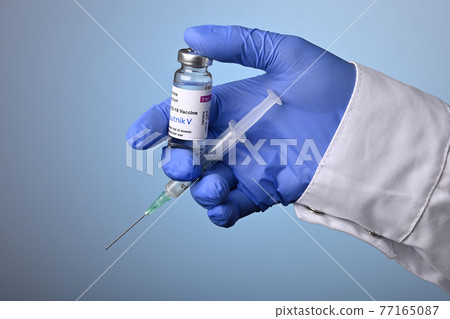 Doctor Hand with Sputnik-V Covid Vaccine Vial and Syringe Doctor Hand with Sputnik-V Covid Vaccine Vial and Syringe 77165087