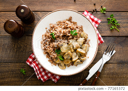 Mushroom buckwheat porridge bowl with fresh parsley 77165372