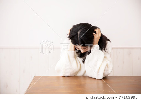 A woman holding a head A woman holding a head 77169993