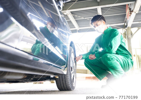 Auto mechanic working with a mask on 77170199