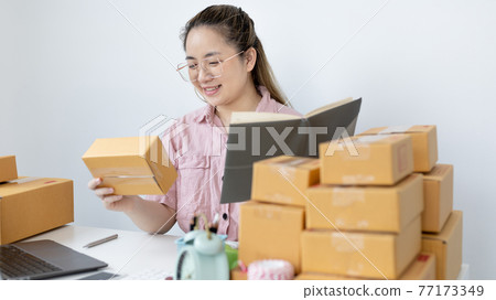 Young woman was happy after receiving an order from an internet customer, New business style for young people working at home and owning businesses, Sell online or Online sell concept. 77173349