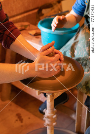 Potter's hands. Making clay products on a potter's wheel. Pottery master class. Potter's hands. Making clay products on a potter's wheel. Pottery master class. 77173482