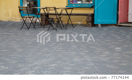 Image of the street cafe and cobblestone 77174144