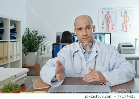 Physician attending online conference 77174425