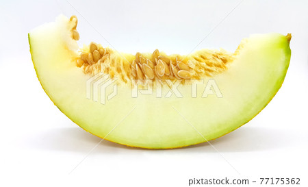 Slice of ripe melon with seeds, close-up Slice of ripe melon with seeds, close-up 77175362