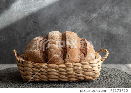 Bread in basket on marbled background Bread in basket on marbled background 77175720