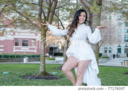 Mexican woman enjoying nature under a tree 77176097