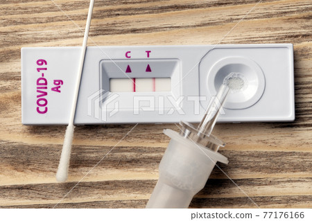 Rapid test cassette for COVID-19 virus close-up on the wooden surface Rapid test cassette for COVID-19 virus close-up on the wooden surface 77176166
