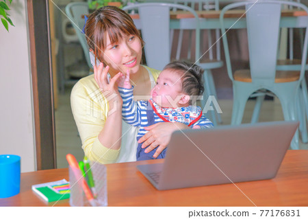Mother calling an infant reaching for a smartphone Mother calling an infant reaching for a smartphone 77176831