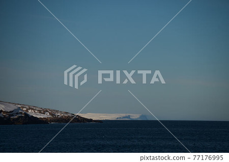 Arctic timelapse of ice mountain ranges at snow landscape. Nobody wild nature environment scenery of climate change. Cold winter at white snowy cloudy day with iceberg glacier mount at Antarctica. 77176995