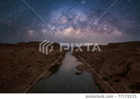 Sam Phan Bok with milky way and stars at night, Ubon Ratchathani, Thailand. Dry rock reef in the Mekong River with mountain hills. Nature landscape background. Grand Canyon of Thailand. Sam Phan Bok with milky way and stars at night, Ubon Ratchathani, Thailand. Dry rock reef in the Mekong River with mountain hills. Nature landscape background. Grand Canyon of Thailand. 77178155