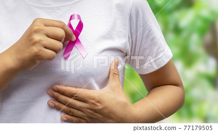 Pink ribbon on female hand, healthcare concept and breast cancer symbol. 77179505