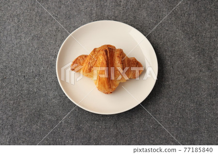 Croissant on a plate 77185840