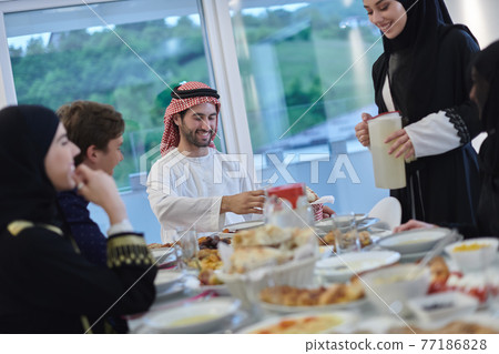 Muslim family having iftar together during Ramadan Muslim family having iftar together during Ramadan 77186828