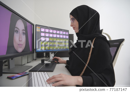 Young muslim girl working on the computer from home 77187147
