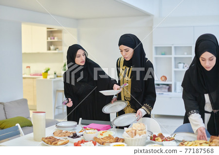 Young muslim women preparing food for iftar during Ramadan 77187568
