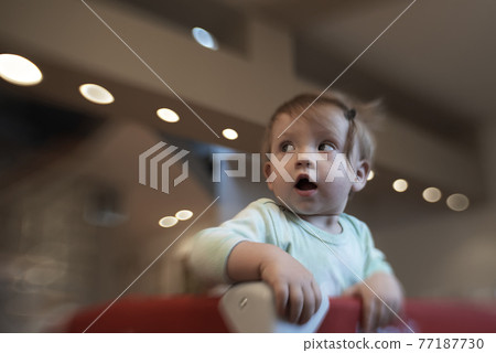cute little baby playing in mobile bed 77187730