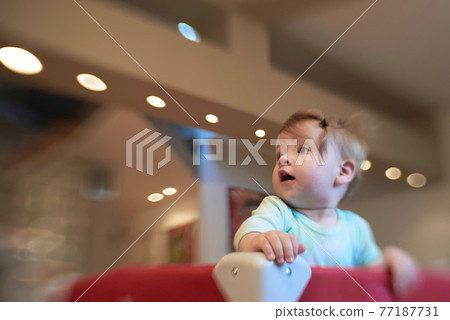cute little baby playing in mobile bed cute little baby playing in mobile bed 77187731