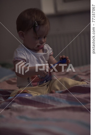 cute little one year old baby and making first steps in bed cute little one year old baby and making first steps in bed 77187867