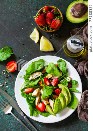 Healthy food, diet lunch menu concept, ketogenic diet and paleodiet. Summer salad with strawberries, grilled chicken and avocado on a stone table. Top view flat lay. Healthy food, diet lunch menu concept, ketogenic diet and paleodiet. Summer salad with strawberries, grilled chicken and avocado on a stone table. Top view flat lay. 77188523