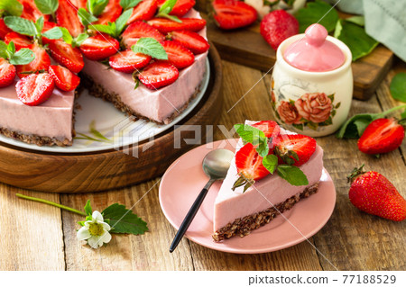 Summer diet dessert without baking Gluten-free, birthday menus. Strawberry cheesecake on a granola with fresh strawberries on a on rustic table. 77188529