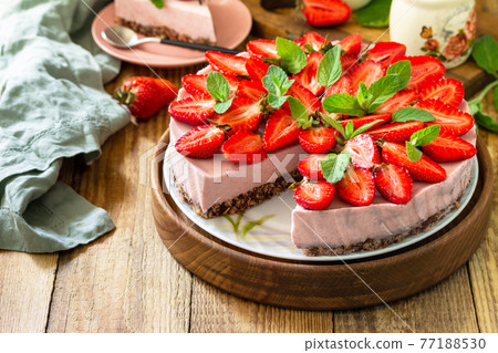 Summer diet dessert without baking Gluten-free, birthday menus. Strawberry cheesecake on a granola with fresh strawberries on a on rustic wooden table. Copy space. 77188530