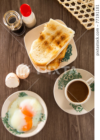 Oriental breakfast set in Malaysia consisting of coffee, nasi lemak, toast bread and half-boiled egg Oriental breakfast set in Malaysia consisting of coffee, nasi lemak, toast bread and half-boiled egg 77191181