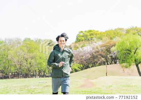 Young man running in the park Young man running in the park 77192152