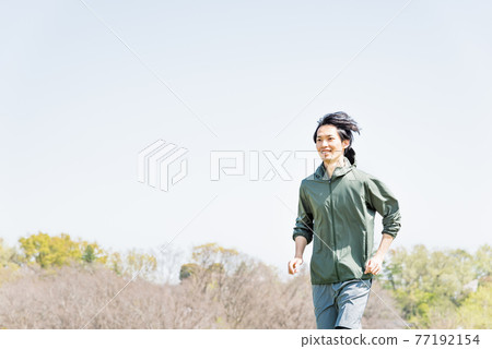 Young man running in the park Young man running in the park 77192154