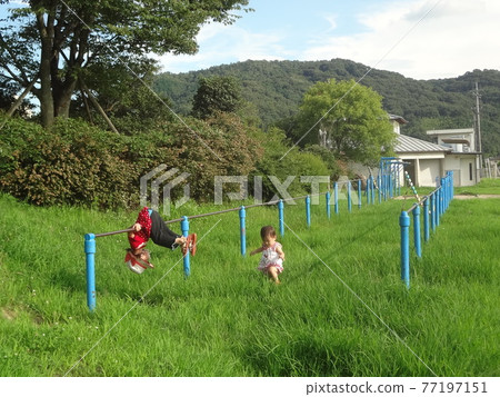 Children playing on the horizontal bar Children playing on the horizontal bar 77197151