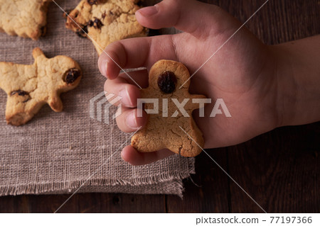 Healthy homemade cookies on wooden background with child's hand Healthy homemade cookies on wooden background with child's hand 77197366